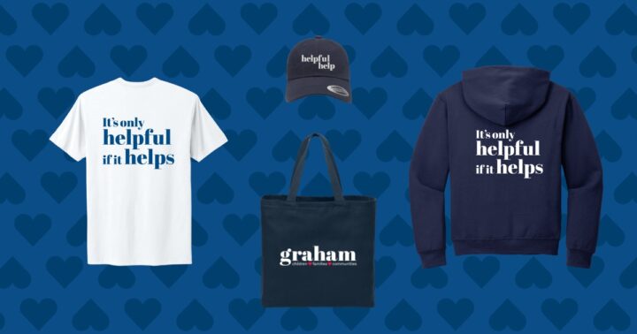 A white t-shirt with blue text that says "It's only helpful if it helps." A navy blue sweatshirt with the same phrase in white text. A navy blue baseball cap with the phrase "helpful help" in white. A navy blue tote bag with the Graham logo in white.